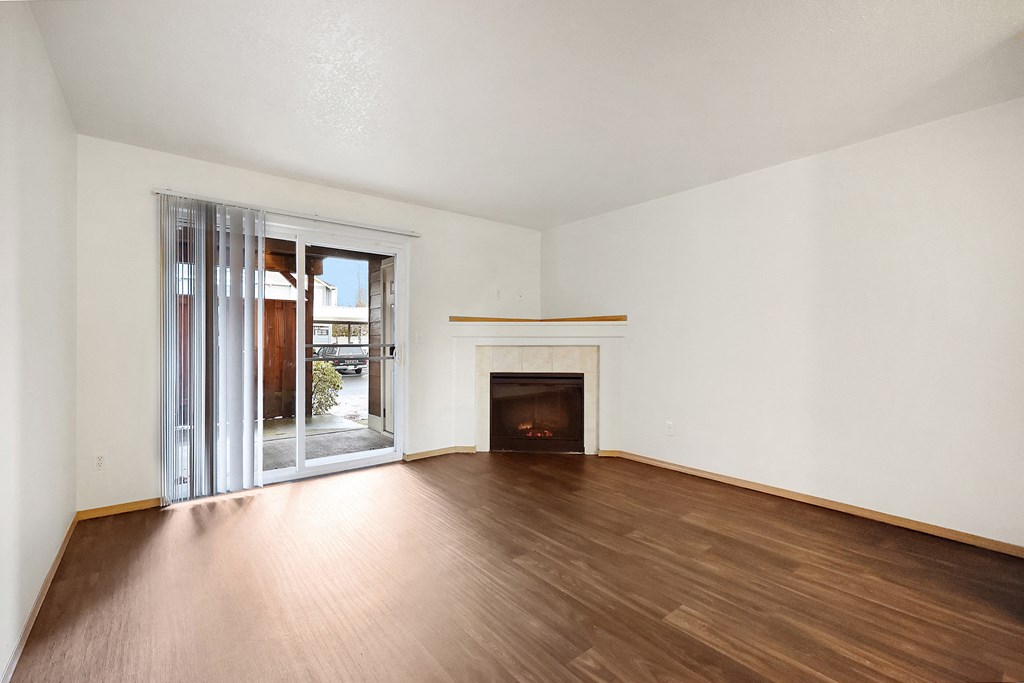 a living room with hardwood floors and a fireplace