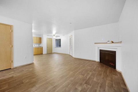A living room with a fireplace and hardwood floors.