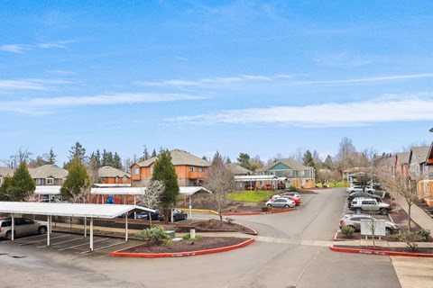 a city street with cars parked in a parking lot