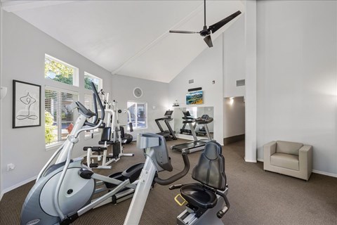 A spacious home gym with a variety of exercise equipment.