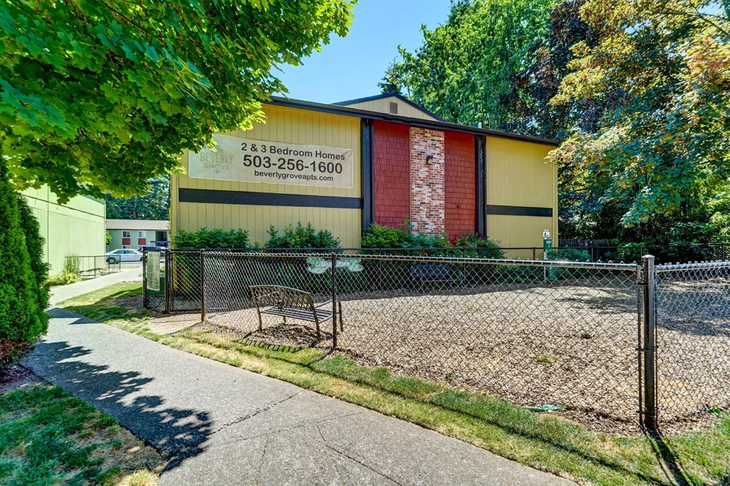 a bench in front of a building with a sign on it