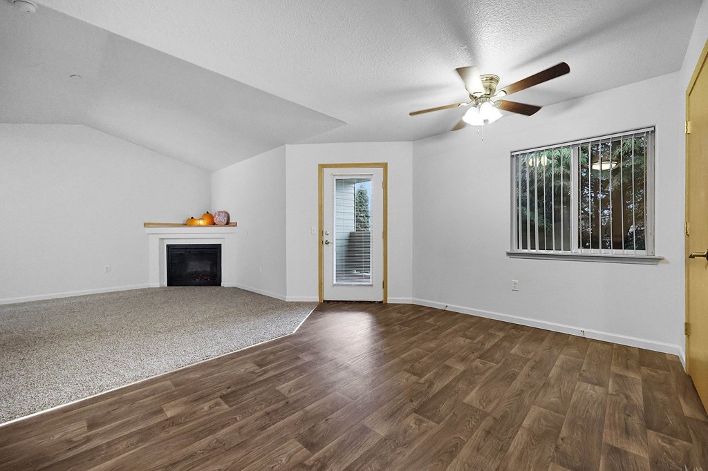 A room with a fireplace and a ceiling fan.