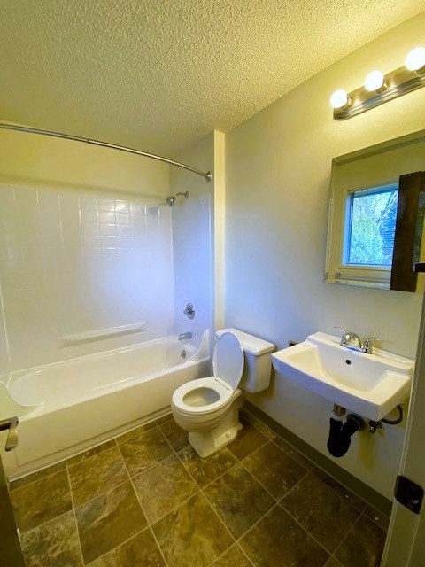 Nell Anna Court bathroom with a toilet, sink, and bathtub.