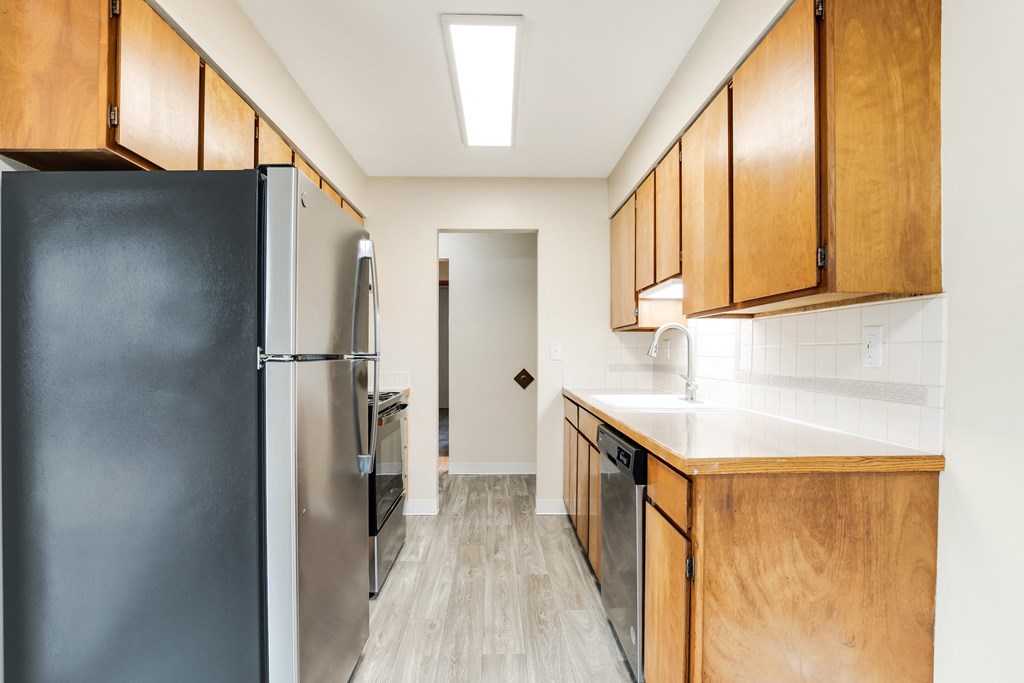 a kitchen with stainless steel appliances and wooden cabinets