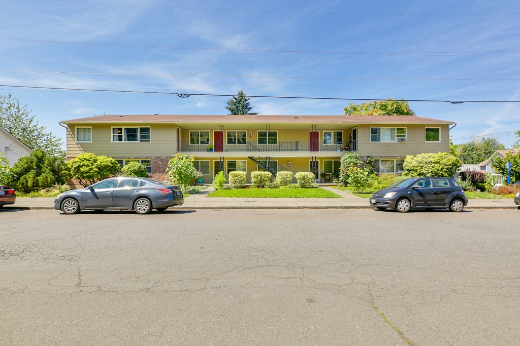 Monroe Manor Apartments with cars parked in front.