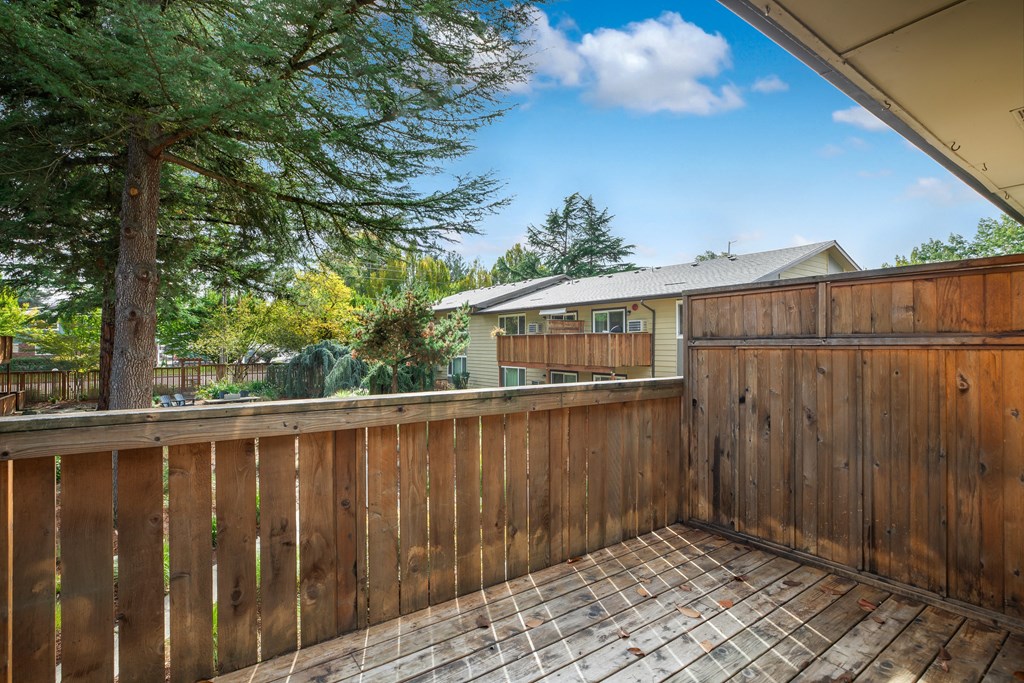 a backyard deck with a fence and a house