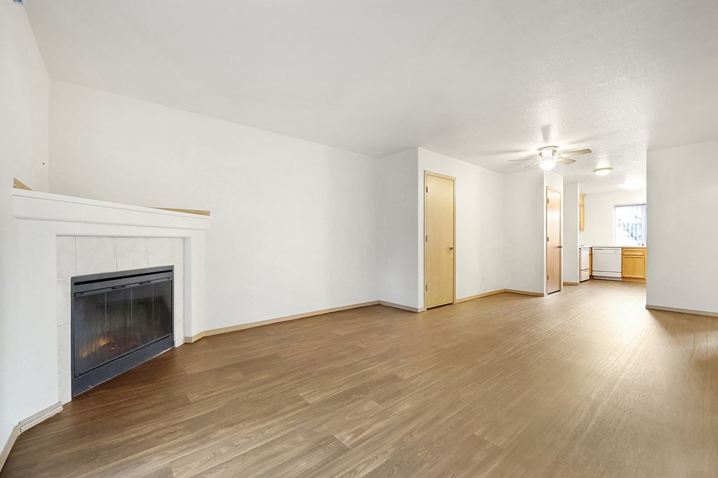 a living room with a fireplace and hardwood floors