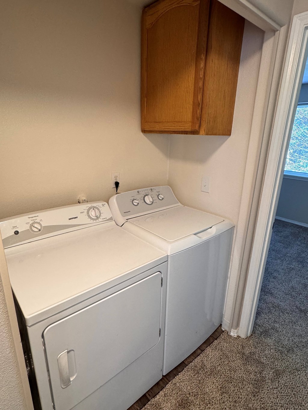 A white washer and dryer in a laundry room.