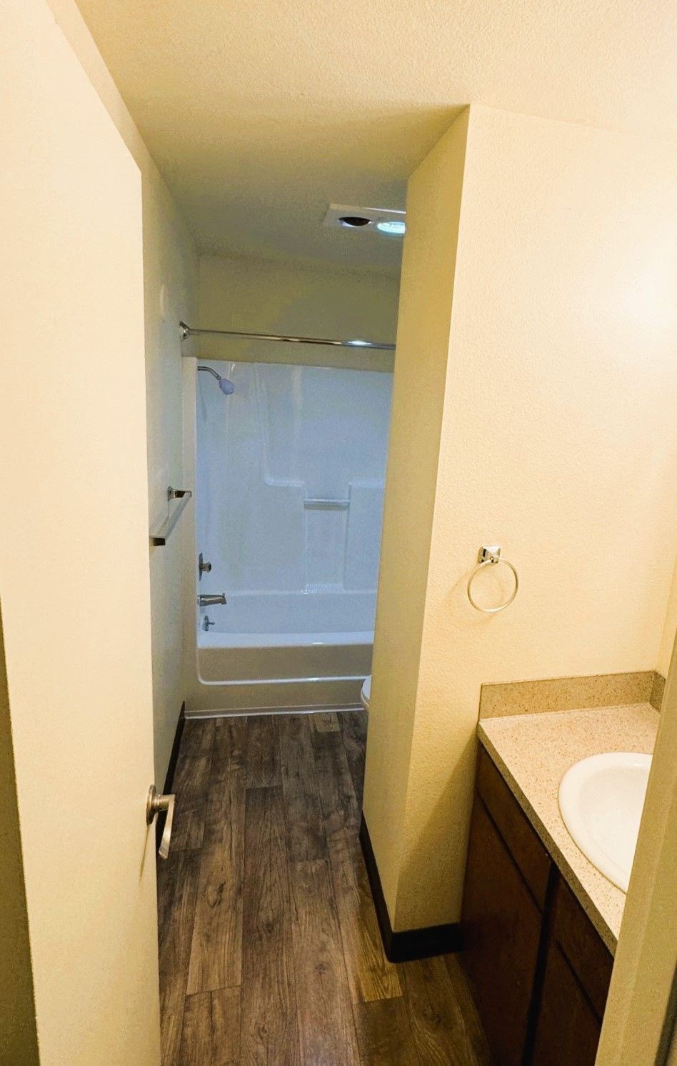 A small bathroom with a sink and a shower.