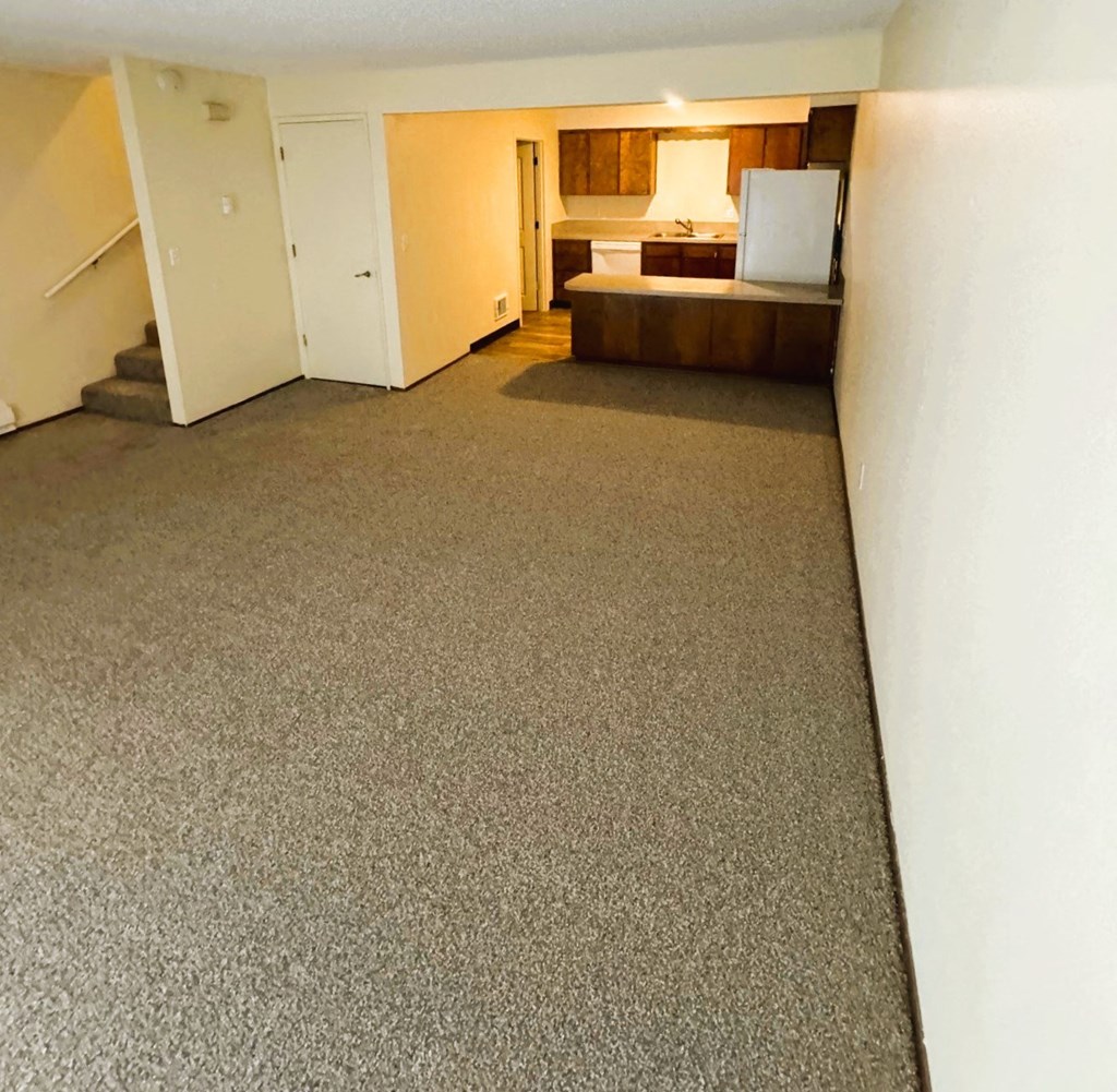 A bedroom with a bed, dresser, and mirror.