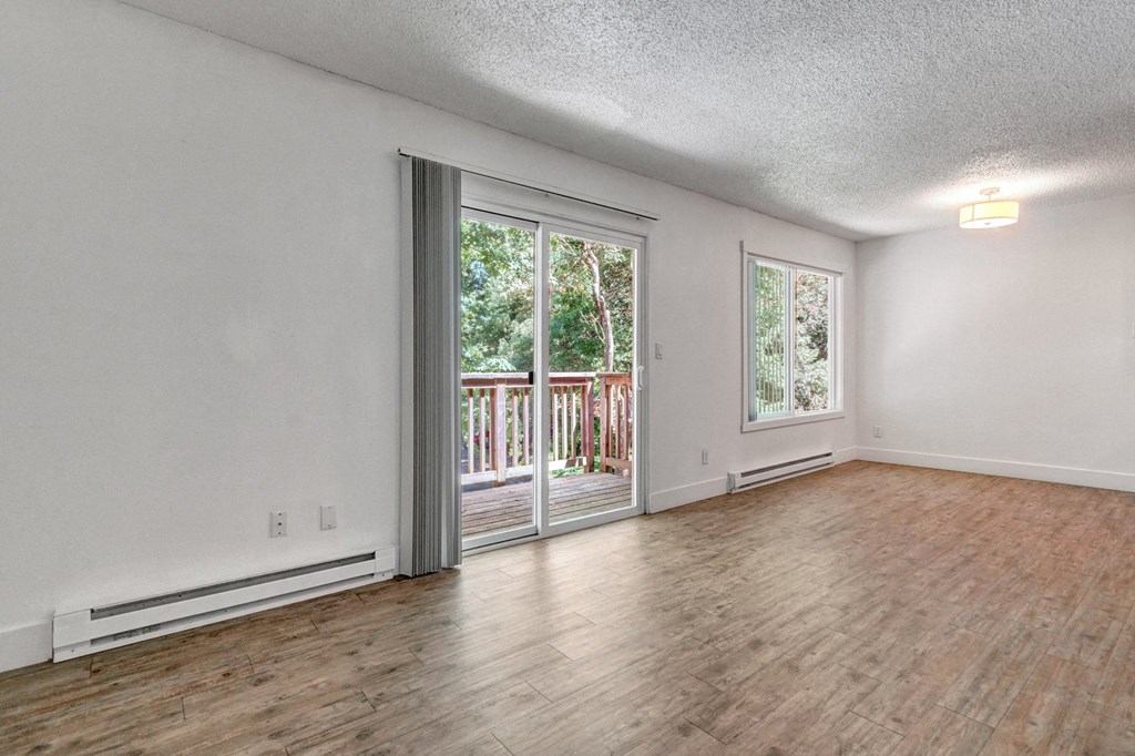a living room with hardwood floors and white walls