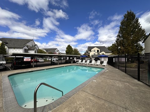 A small pool with a metal ladder in the middle of it.