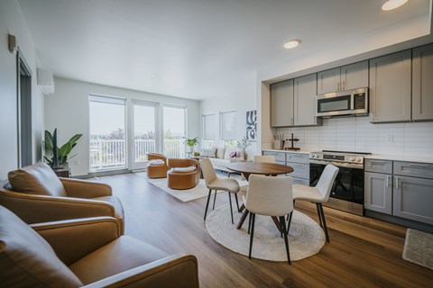 A modern kitchen with a dining table and chairs.