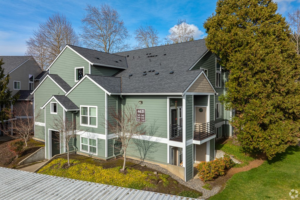 A green house with a metal roof and a sign that says "ASA".