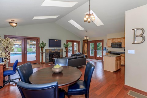 A dining room with a wooden table and blue chairs.