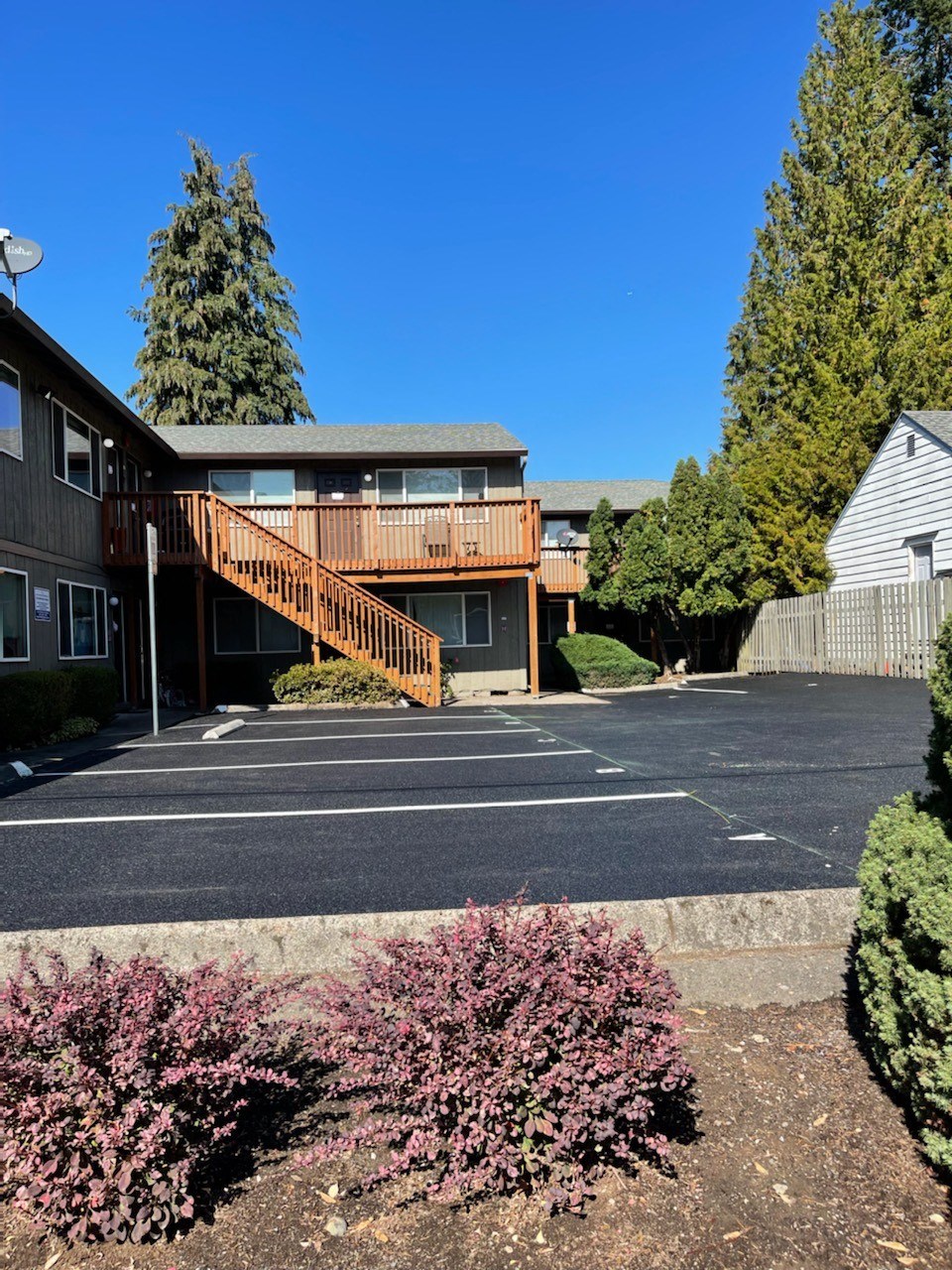an empty parking lot in front of a building