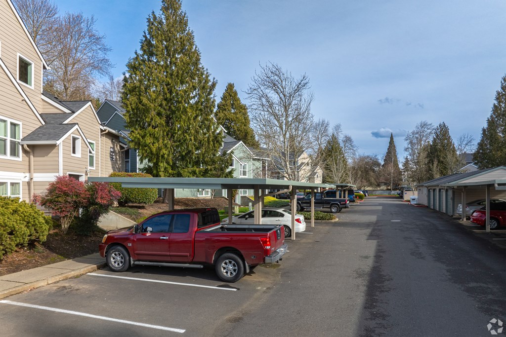 A red pickup truck is parked in a parking lot.