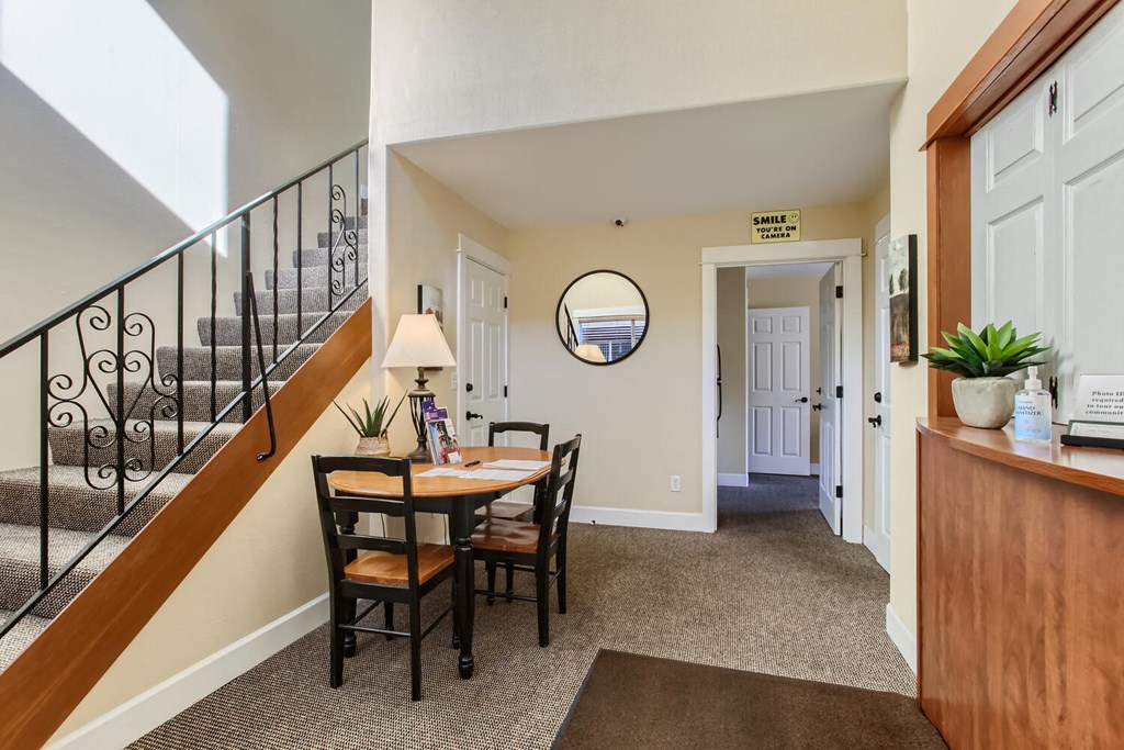 a dining room with a table and chairs and a staircase
