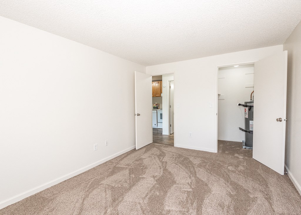 a bedroom with a carpeted floor and white walls