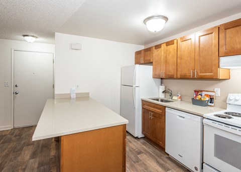 the preserve at ballantyne commons apartment kitchen with white appliances and wooden cabinets