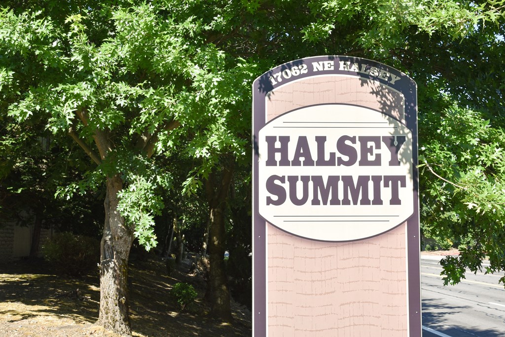 a sign that says halley summit with trees in the background