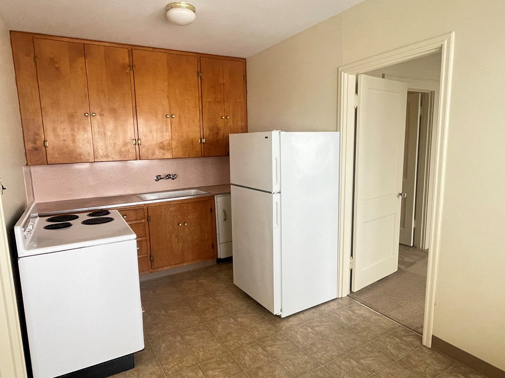 a kitchen with a refrigerator and a stove