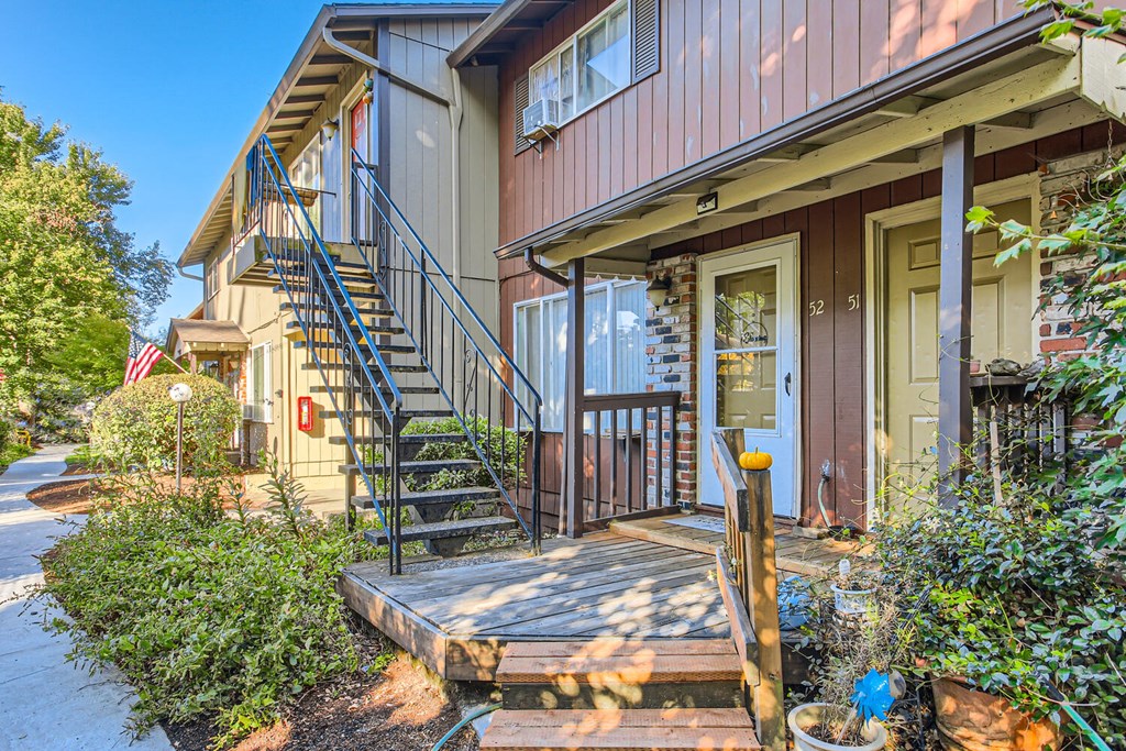 the front of a house with stairs and a porch