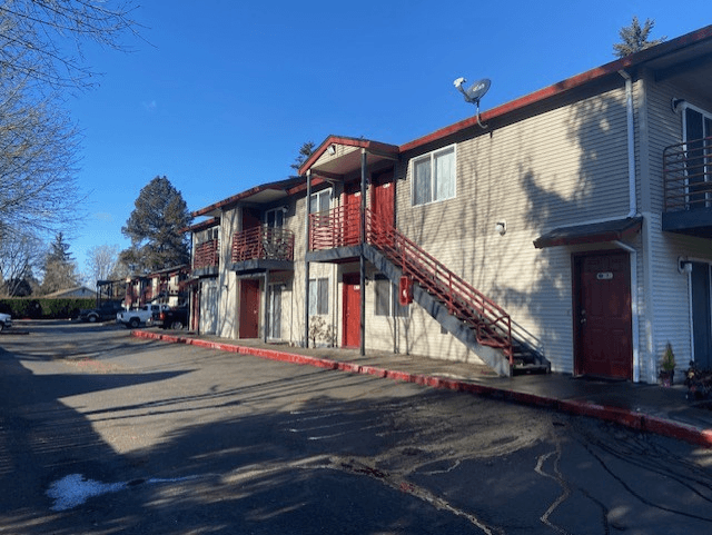 A row of townhouses with a clear blue sky above.