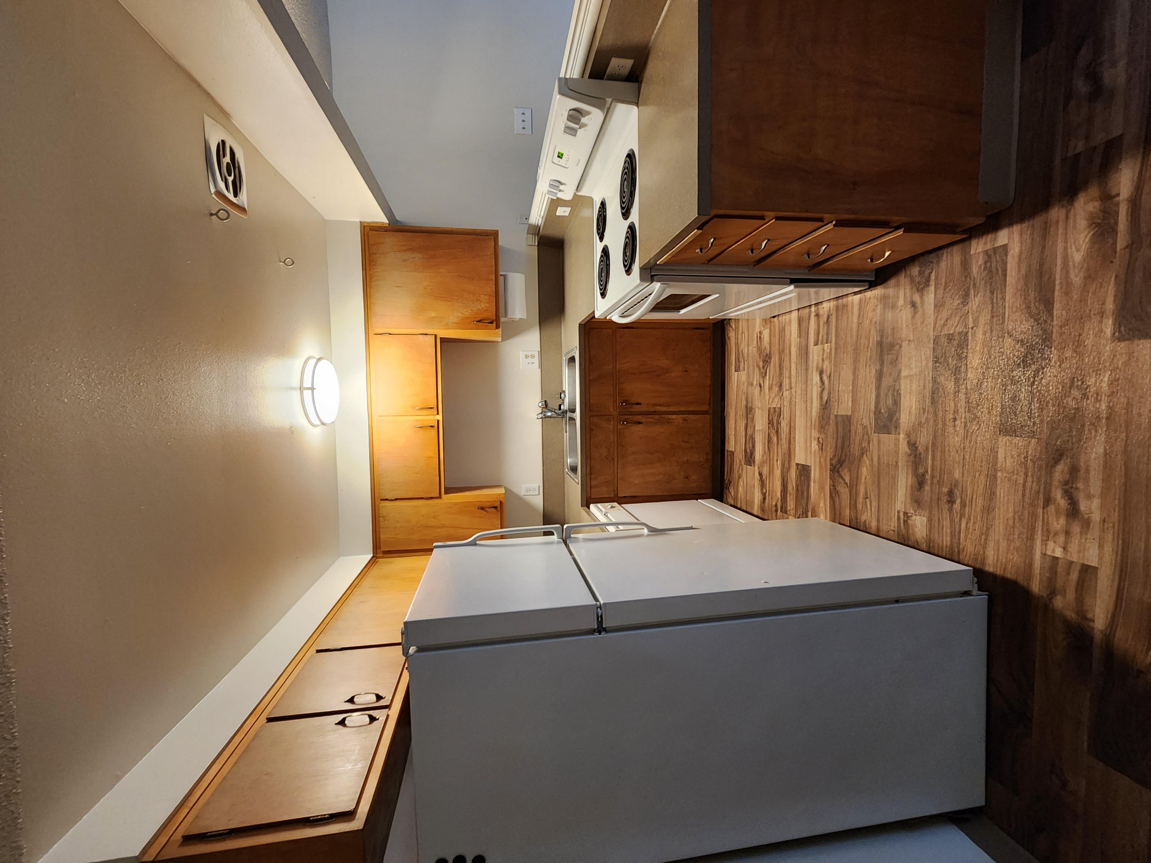 a kitchen with a refrigerator and a counter top