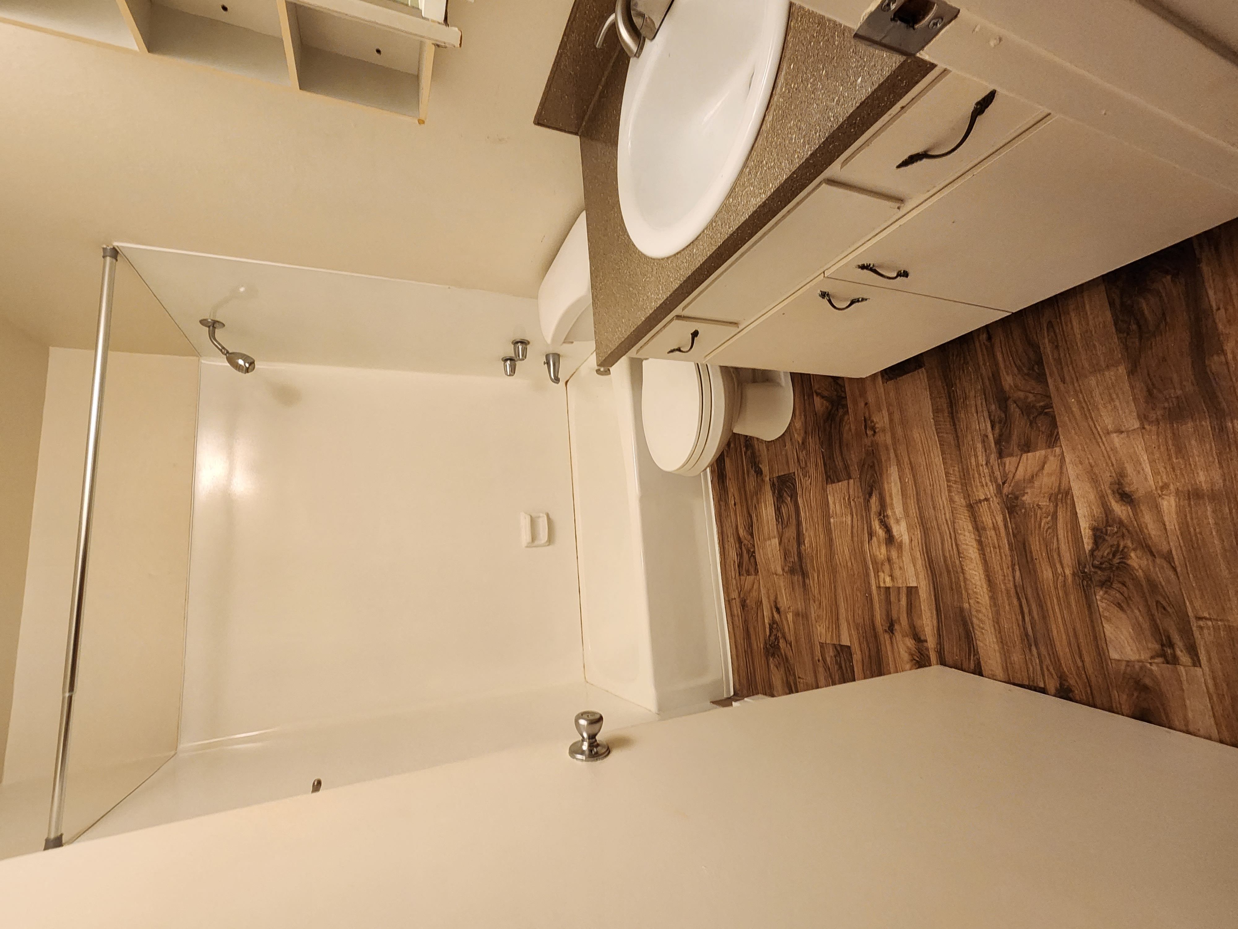 a bathroom with a toilet sink and shower