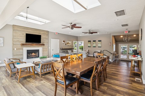 A dining room with a wooden table and chairs.