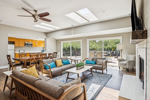 A living room with a grey couch and a wooden table.
