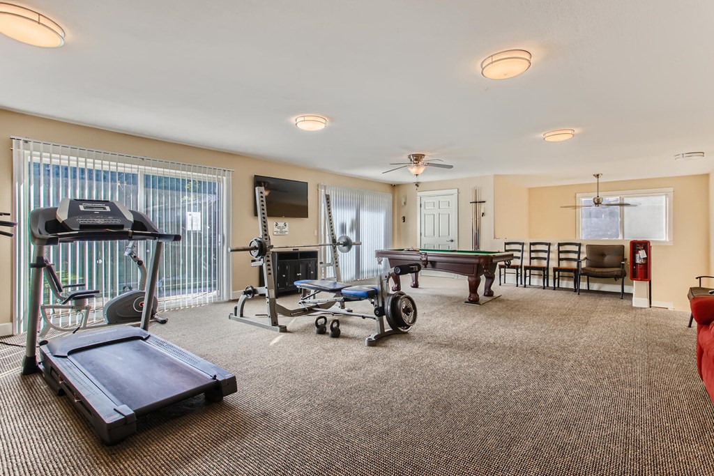 a gym with a ping pong table and a pool table