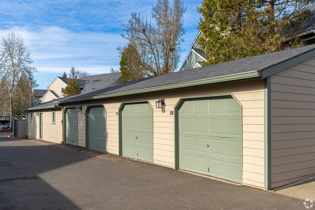 A row of garage doors in front of a house.