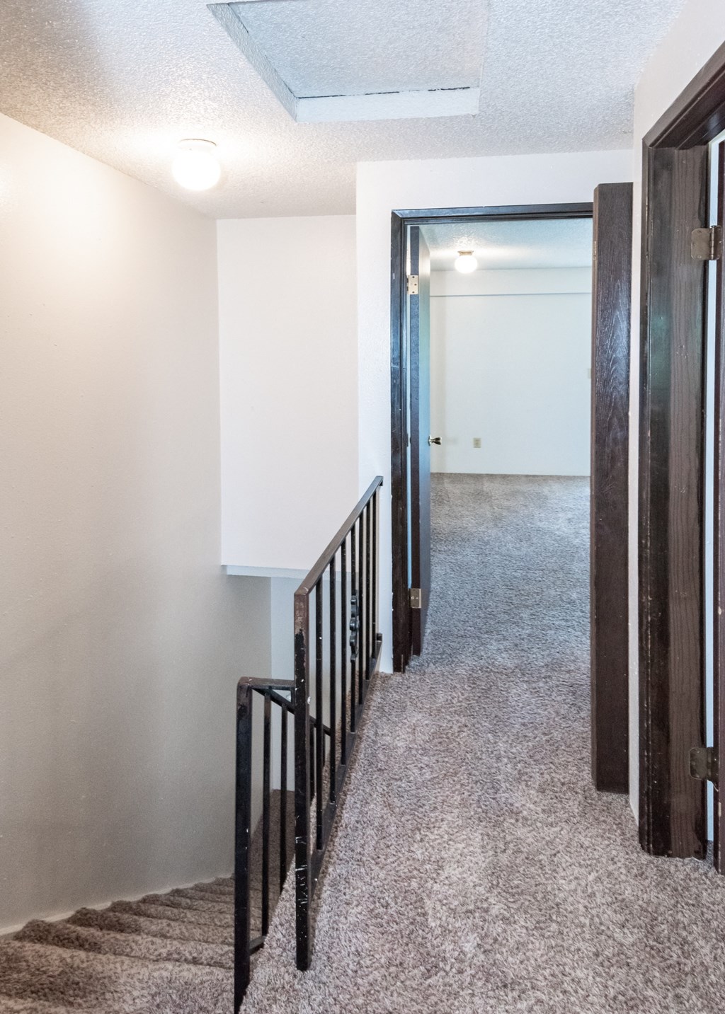 a view of the hallway from the bottom of the stairs in a 555 waverly unit