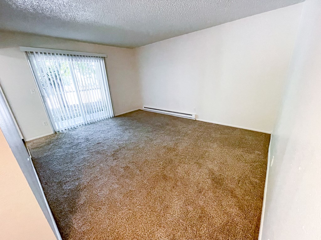 an empty living room with a large window
