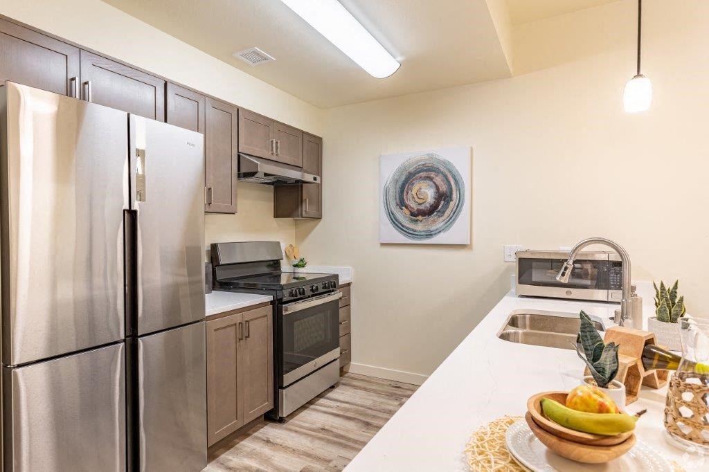 a kitchen with stainless steel appliances and a white counter top