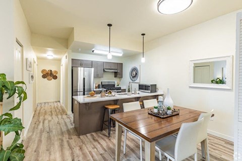a kitchen and dining room with a wooden table