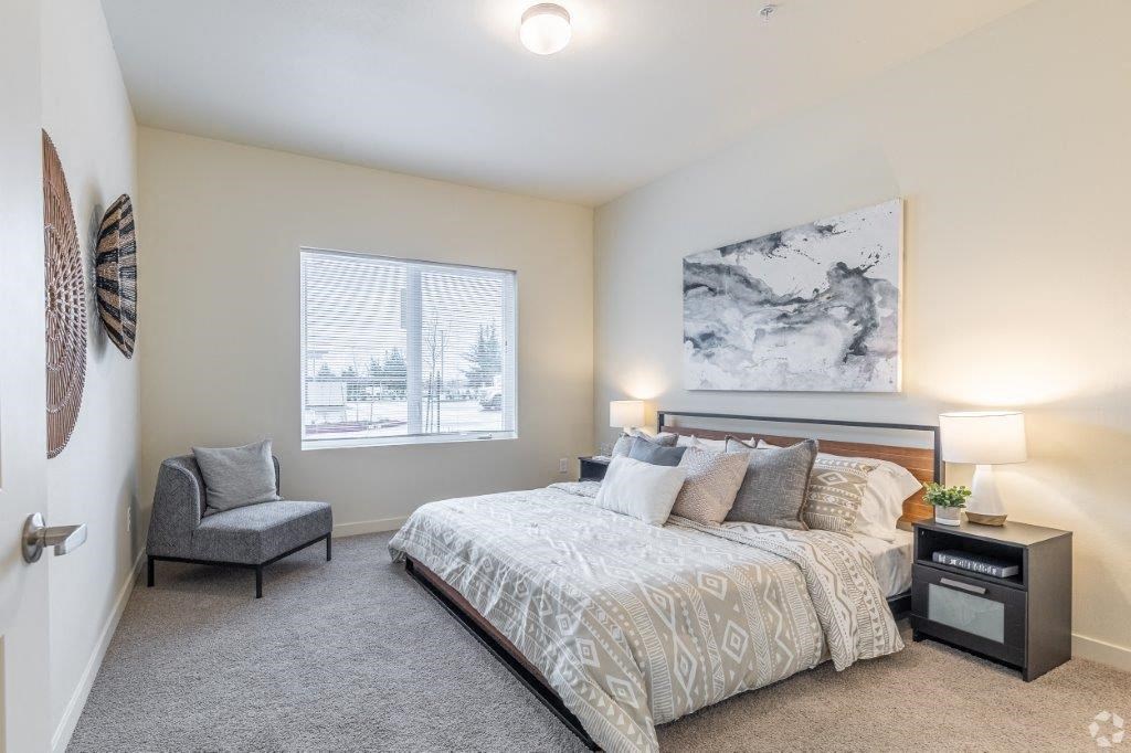 a bedroom with a bed and a chair