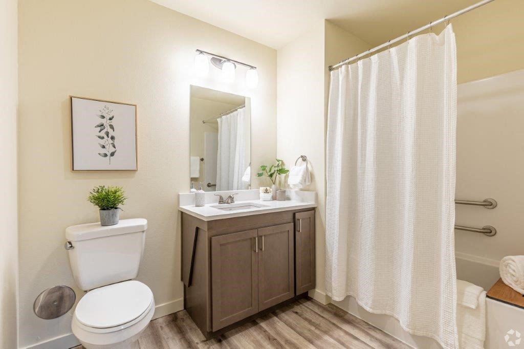 a bathroom with a toilet sink and shower