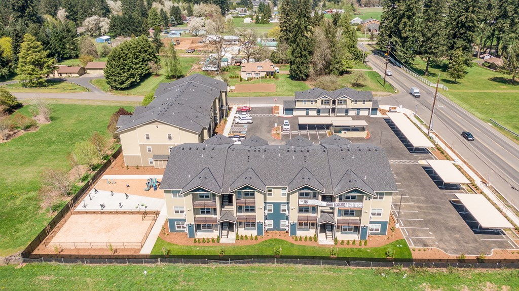 arial view of a large home with a gray roof