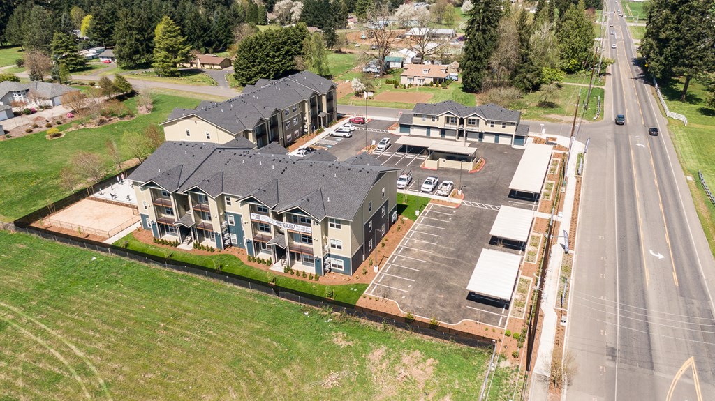 an aerial view of a large home with a gray roof