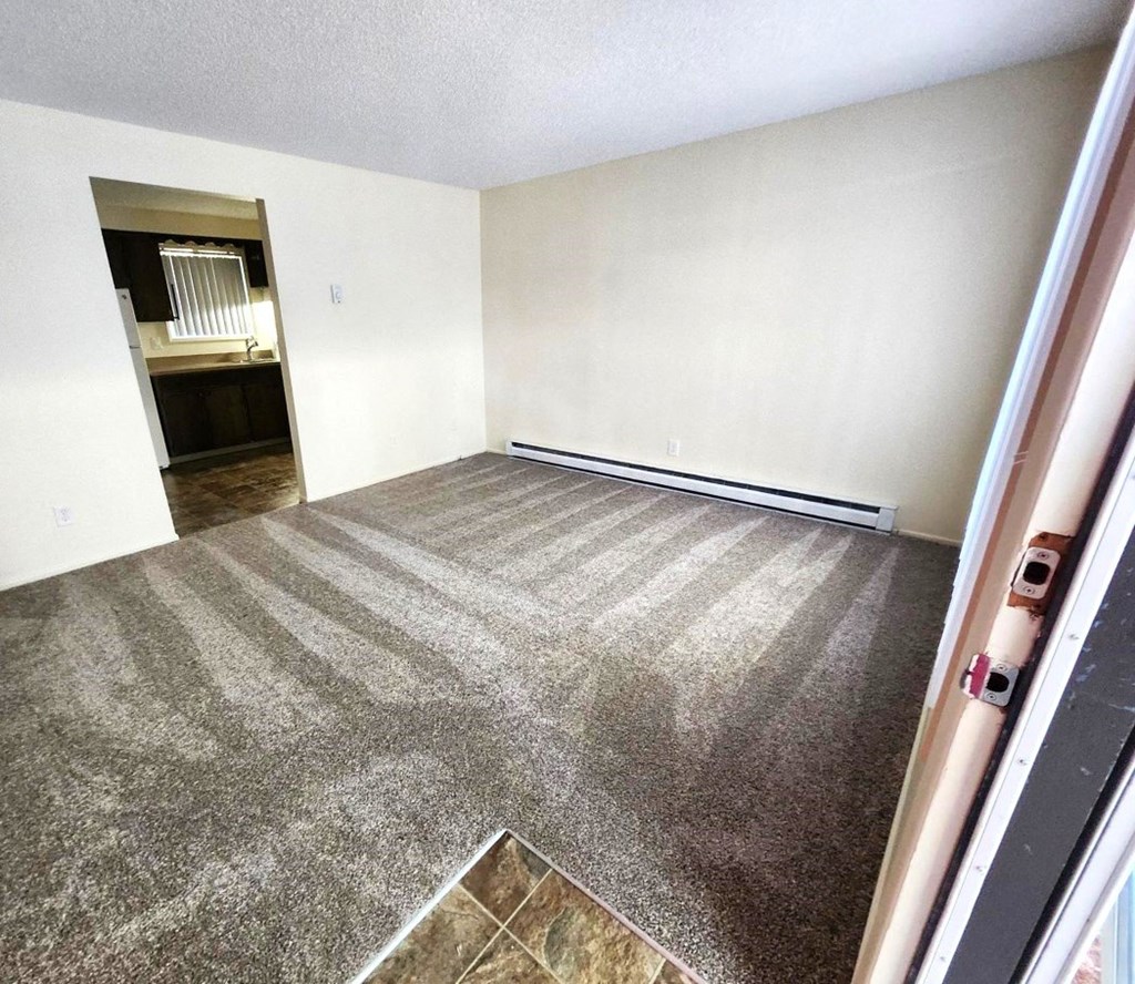 Nell Anna Court room with a carpeted floor and a doorway leading to another room.