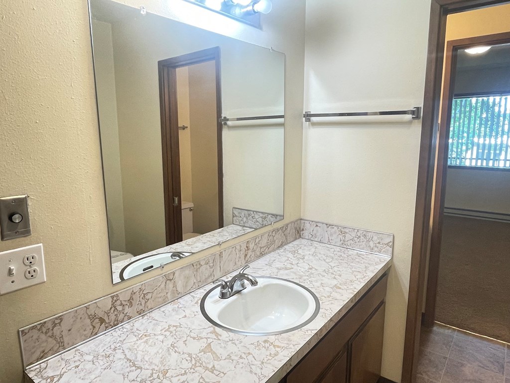 Metro Park Terrace bathroom with a sink and a mirror