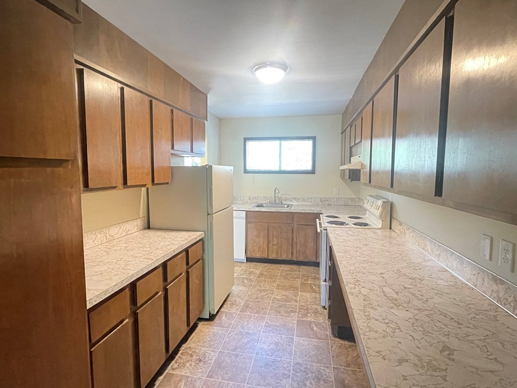 Metro Park Terrace  kitchen with wooden cabinets and a white refrigerator