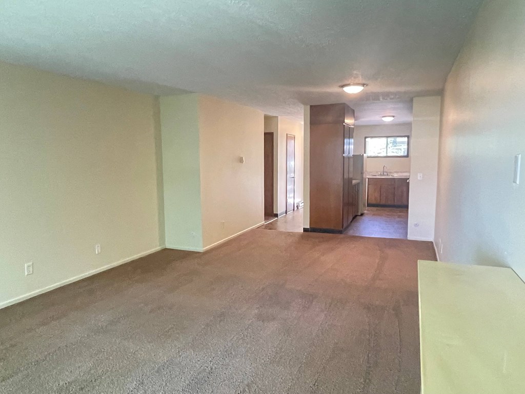 Metro Park Terrace  empty living room with a kitchen in the background