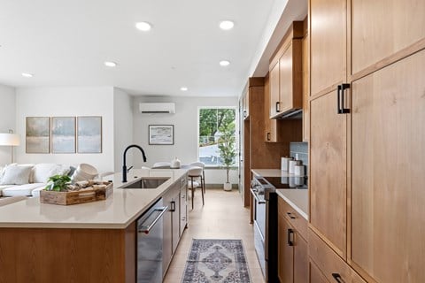 A modern kitchen with wooden cabinets and a large island.