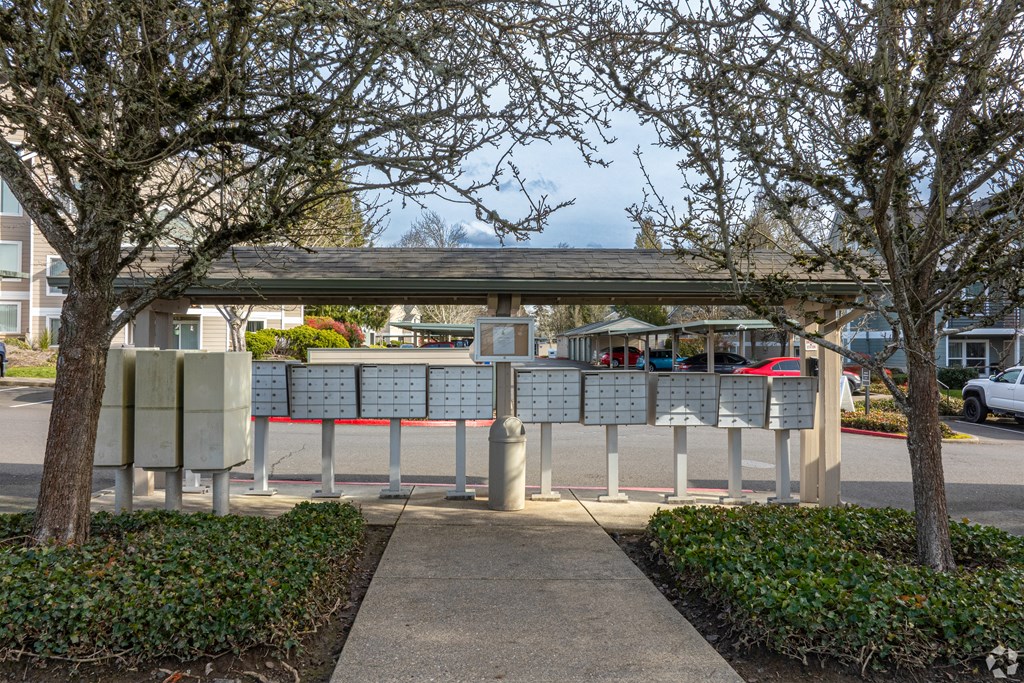 A bus stop shelter with a bench and a signboard is covered with a roof.