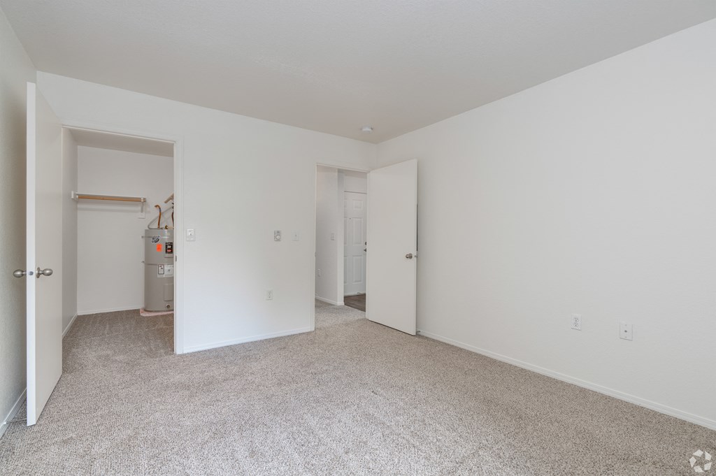 A room with white walls and carpeted floor.