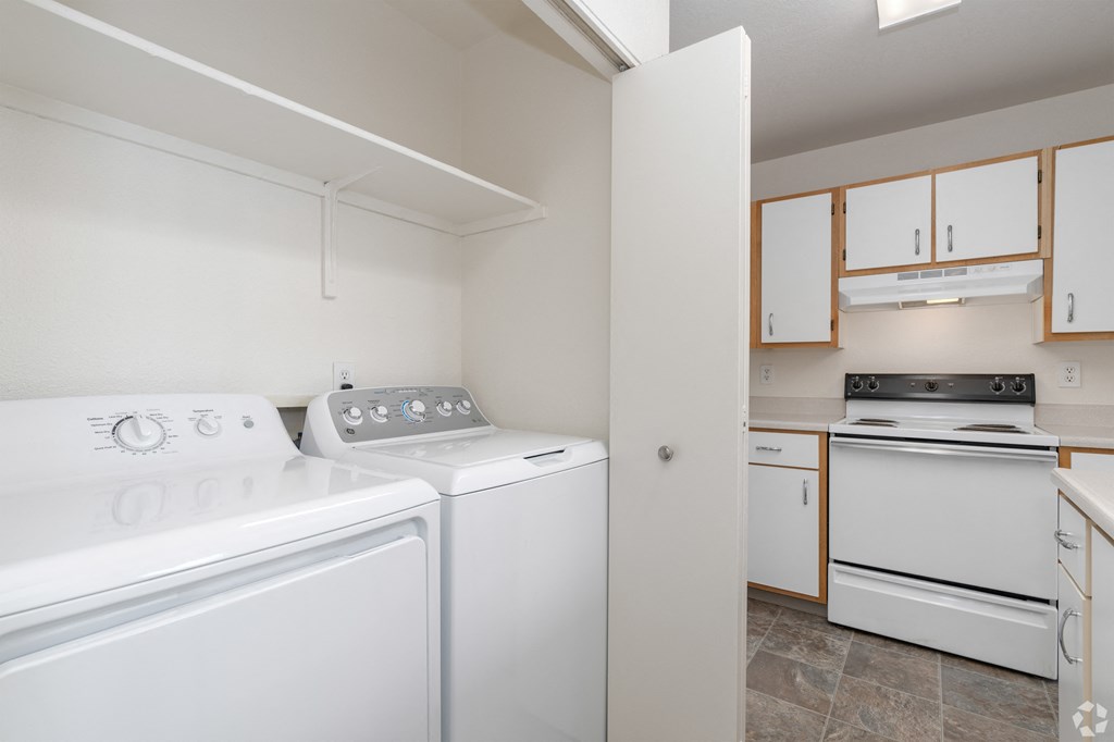 A white washing machine and dryer in a laundry room.